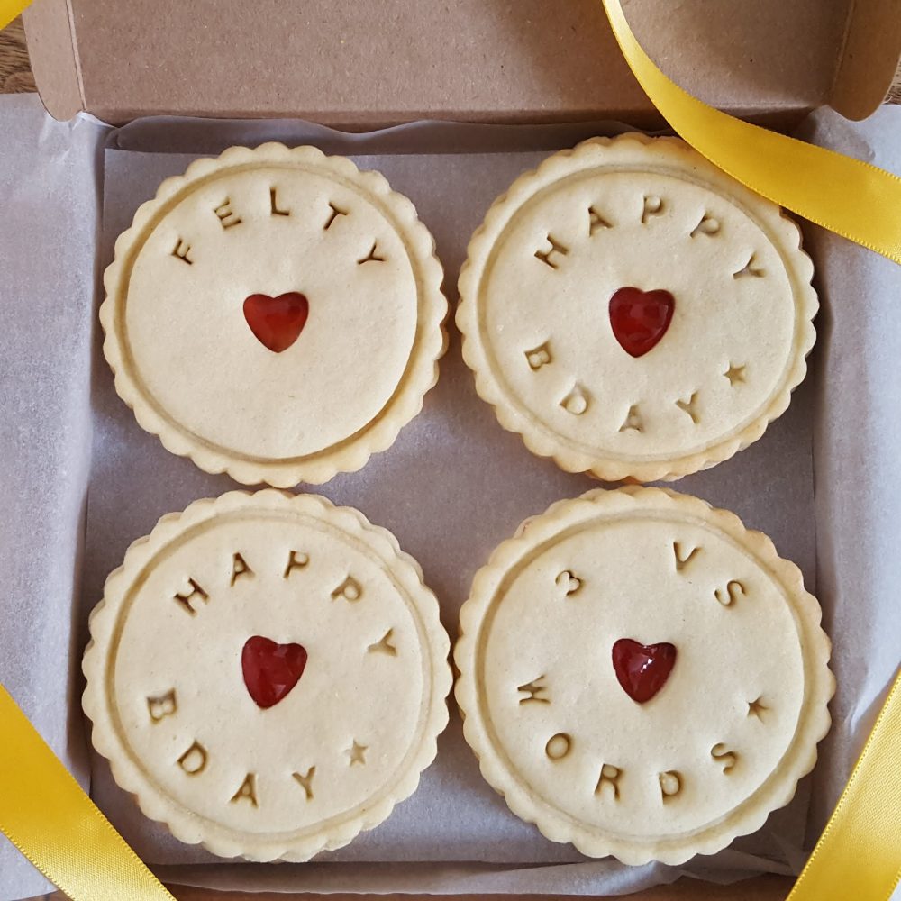 A box of personalised happy birthday biscuits
