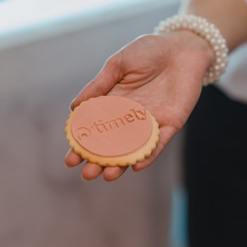 Timely logo impressed biscuits in hand