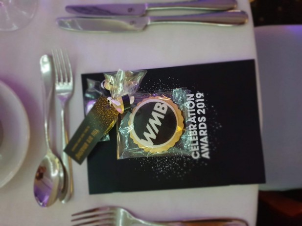 Close up in focus picture of Women mean business award table setting with Bloom Bakers biscuits